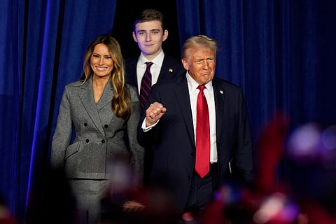 Republican presidential nominee former President Donald Trump, joined by Melania Trump, left, and Barron Trump, arrives to speak at an election night watch party, Wednesday, Nov. 6, 2024.