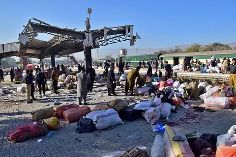 Security officials examine the site of a bomb explosion at railway station in Quetta, southwestern Pakistan.