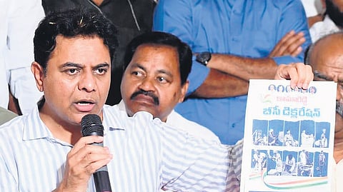 BRS working president KT Rama Rao shows a copy of Congress’ BC Declaration as he speaks during a press conference at the pink party office in Hanamkonda on Sunday