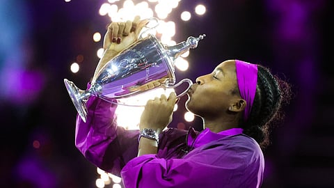 US' Coco Gauff celebrates with her winning trophy after defeating China's Zheng Qinwen in their women's singles final tennis match at the WTA Finals Championship in Riyadh on November 9, 2024.
