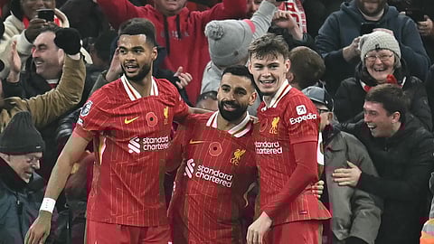 Liverpool's Egyptian striker #11 Mohamed Salah (C) celebrates with teammates after scoring their second goal during the English Premier League football match between Liverpool and Aston Villa at Anfield in Liverpool, north west England on November 9, 2024.