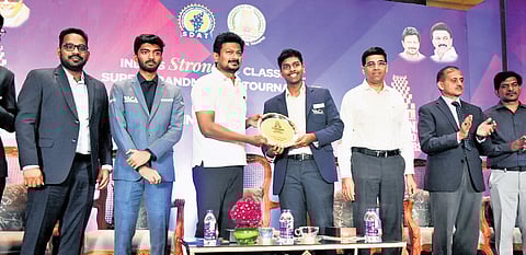 Deputy CM Udhayanidhi Stalin (3rd from left) hands over the trophy to winner Aravindh Chithambaram in Chennai on Monday.