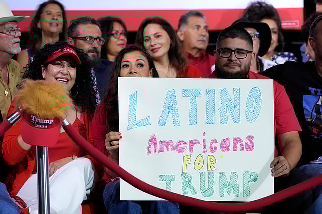 Supporters hold a sign before Republican presidential nominee former President Donald Trump arrives to speak during a campaign event, Sept.12, 2024, in Tucson, Ariz.
