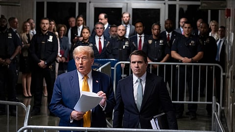 Donald Trump (L), standing with defense attorney Todd Blanche, speaks at the conclusion of proceedings for the day at his trial at Manhattan criminal court, Tuesday, May 14, 2024, in New York.