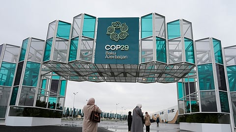 People enter the venue ahead of the COP29 U.N. Climate Summit, Saturday, Nov. 9, 2024, in Baku, Azerbaijan.