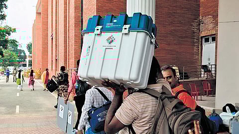 Staff deployed for election duty leave for their respective polling booths in Archakarahalli in Channapatna, Ramanagara district, on Tuesday.