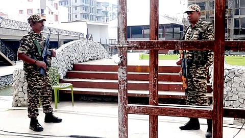 Security personnel stand guard during a raid by the Enforcement Directorate in connection with a money laundering investigation linked to alleged illegal infiltration of Bangladeshi nationals, in Ranchi.
