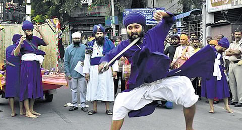 Sikh youths perform Gatka skills during the Nagar Keertan as part of the 555th Guru Nanak Jayanti on Wednesday