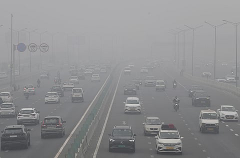 Vehicles ply on a road amid the smog as air quality falls to ‘severe’ category, at Mayur Vihar Phase 1, in New Delhi on Wednesday.