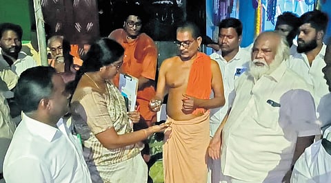 Pontiff of Suriyanarkoil adheenam handing over the keys of the mutt to HR and CE inspector T Aruna on Tuesday night