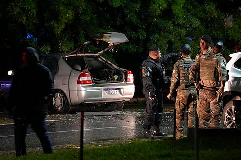 Police inspect a vehicle outside the Supreme Court in Brasília, Brazil, following an explosion, Wednesday, Nov. 13, 2024.