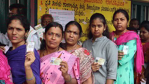 People wait in queue to cast vote.