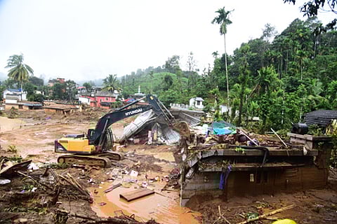 Rescue workers demolishing a house on the river bank at Vellarimala in search of missing people in the landslide