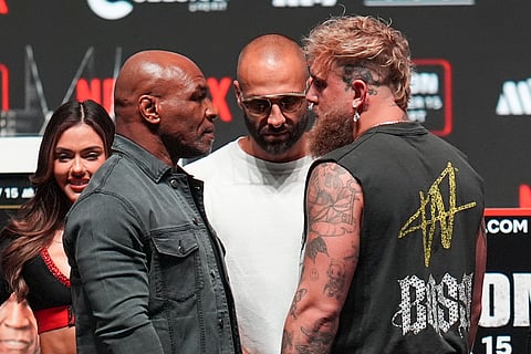 Mike Tyson, front left, and Jake Paul, front right, face off during a news conference ahead of their fight, Wednesday, Nov. 13, 2024, in Irving, Texas.