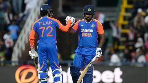India's Sanju Samson, right, and batting partner Tilak Varma celebrate scoring runs during the fourth T20 cricket match between South Africa and India at the Wanderers Stadium in Johannesburg, South Africa, Friday, Nov. 15, 2024.