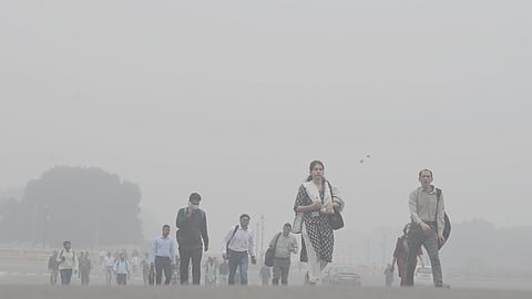 People seen while going to office on a cold fog winter morning 9 am in New Delhi.