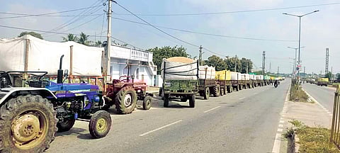 Tractors laden with paddy queue at a rice mill in Miryalaguda on Friday