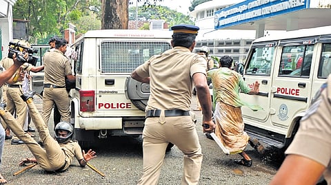 A police officer being pushed down by one of the protestors during the protest march organised by ABVP against the relocation of the main gate of SMV Government Model HSS, on Friday