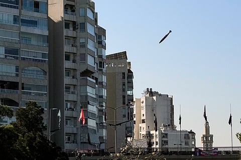 A bomb dropped from an Israeli jet prepares to hit a building in Tayouneh, Beirut, Lebanon, Friday, Nov. 15, 2024.