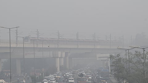 Commuters wade through dense smog as air quality dips to the Severe category, in New Delhi on Thursday.