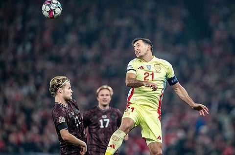 Denmark's Morten Hjulmand and Spain's Mikel Oiarzabal vie for the ball during the match.