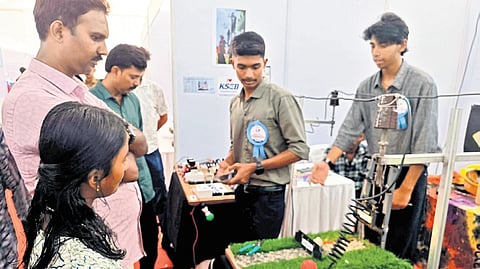 Ashish K M and Muhammad Hadhi of Government VHSS, Kadappuram, Chavakkad, Thrissur, demonstrate their system for preventing electric shocks to workers handling power lines