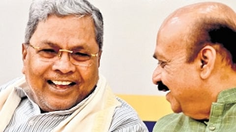 Chief Minister Siddaramaiah and BJP MP Basavaraj Bommai share a light moment at the Ramanashree Sharana Prashasti award function in Bengaluru on Monday