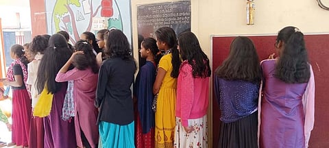 A student displaying the hair cut by the school principal in Alluri Sitarama Raju district.