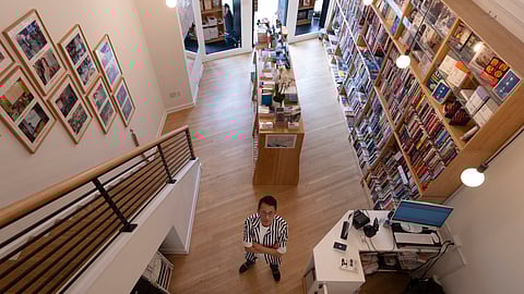 Yu Miao, owner of JF Books, poses for a photograph in his bookstore in Washington.