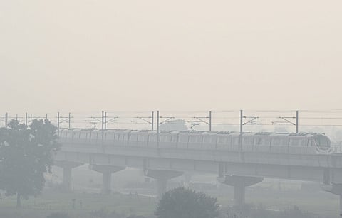 A Metro train runs on its tracks amid smoggy conditions on Tuesday | Parveen Negi