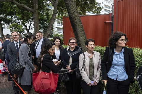 Representatives from various consulates wait in line outside the West Kowloon Magistrates' Courts in Hong Kong Tuesday, Nov 19, 2024, ahead of the sentencing in national security case.