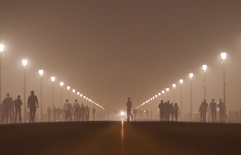 People visit the Kartavya Path amid smog, in New Delhi, Monday, Nov. 18, 2024.