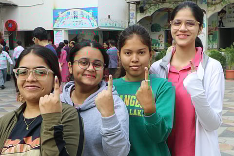 First time voters show their fingers marked with indelible ink after casting votes at a polling station during the Maharashtra Assembly elections, in Nagpur, Wednesday, Nov. 20, 2024.