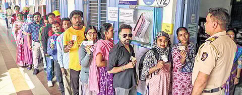 People queue up to cast votes at a polling station in Maharashtra’s Nagpur on Wednesday.