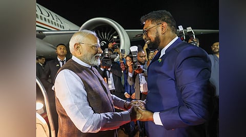 Prime Minister Narendra Modi being welcomed by Guyana President Mohamed Irfaan Ali upon his arrival at the airport in Georgetown, Guyana, on Wednesday.