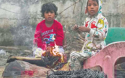 Children looking for warmth as the temperature dips in the capital on Tuesday.
