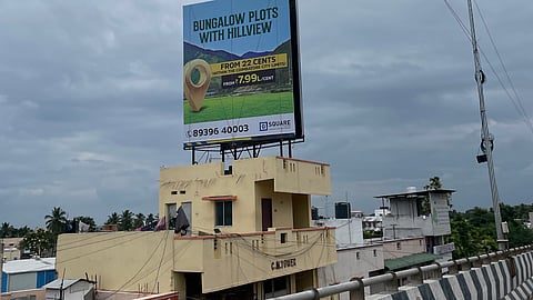 Advertisement hoardings, placed atop iron railings erected on the buildings alongside the Kavundampalayam flyover