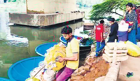 Coracle fishers vacate from underneath the Kundannoor bridge on Thursday