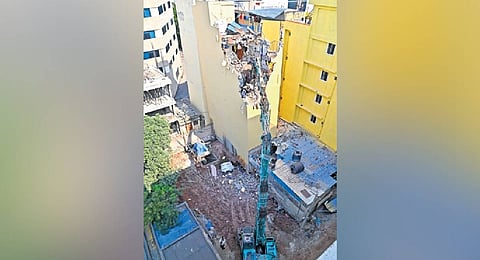 Tilting Gachibowli building evacuated and demolished; tenant injured amid panic.