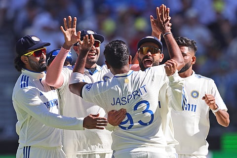 India's captain Jasprit Bumrah, back to the camera celebrates with teammates the wicket of Australia's Nathan McSweeney on the first day of the first cricket test between Australia and India in Perth.
