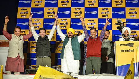 Punjab Chief Minister Bhagwant Mann with AAP National Convenor Arvind Kejriwal and party leader Raghav Chadha during a press conference after the party's victory in three of the Punjab Assembly constituency bypolls, in New Delhi