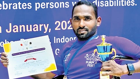 Sidragavali poses with his trophy and certifcate.