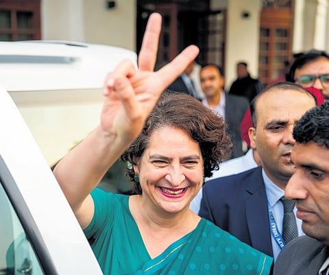 Priyanka Gandhi Vadra flashes victory sign as she leaves after meeting Congress president Mallikarjun Kharge, following her victory in the Wayanad LS bypoll, in New Delhi on Saturday