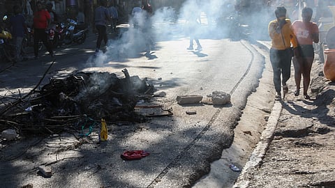 The bodies of suspected gang members who were set on fire by residents, sit in a pile in the middle of a road in the Pétion-Ville neighborhood of Port-au-Prince, Haiti.