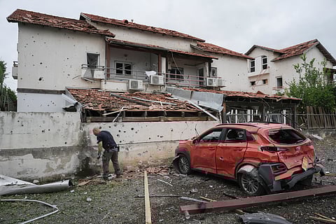 Israeli police bomb squad inspect the site after a missile fired from Lebanon hit the area in Petah Tikva, outskirts of Tel Aviv, Israel, Sunday Nov. 24, 2024.