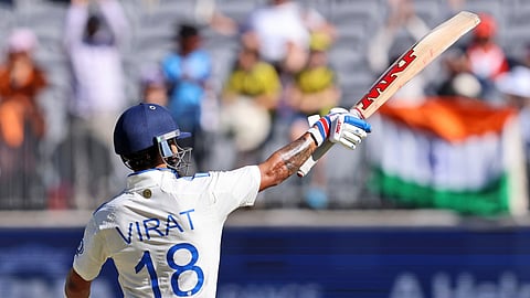 Virat Kohli celebrates his fifty runs on the third day of the first cricket test between Australia and India in Perth.