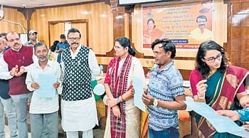Deputy CM Parida and Pujari with beneficiaries at the event