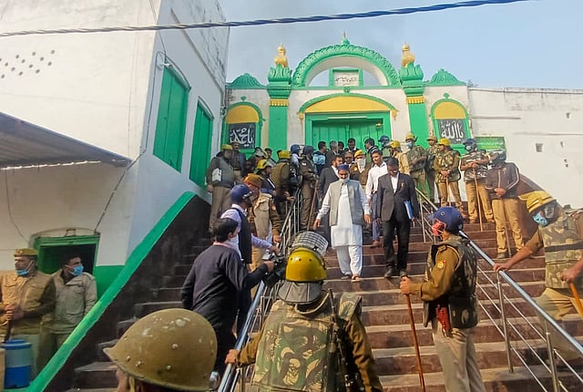 Police stand guard during a second survey of the Jama Masjid.