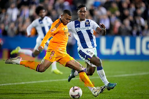 Real Madrid's Kylian Mbappe attempts a shot at goal during a Spanish La Liga soccer match between CD Leganes and Real Madrid in Leganes.