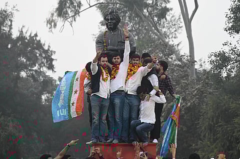 Newly elected DUSU President Ronak Khatri and Joint Secretary Lokesh Chaudhari celebrate at statue of Swami Vivekanand, Delhi University.
